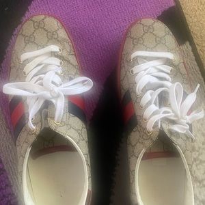A pair of used Gucci sneakers